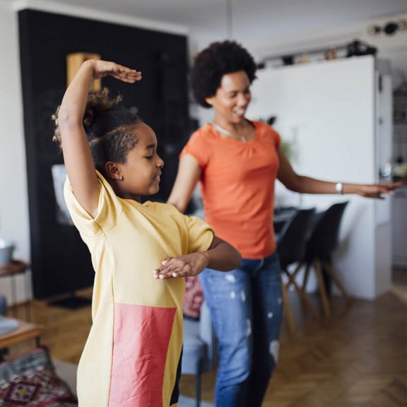 woman and little girl dancing in living room