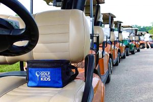 Golf Carts Lined Up With A Color on the Seat With The Golf Fore Kids logo in blue